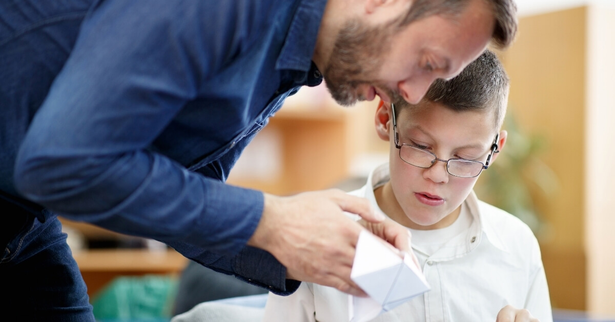 Male educator supporting a child with special educational needs